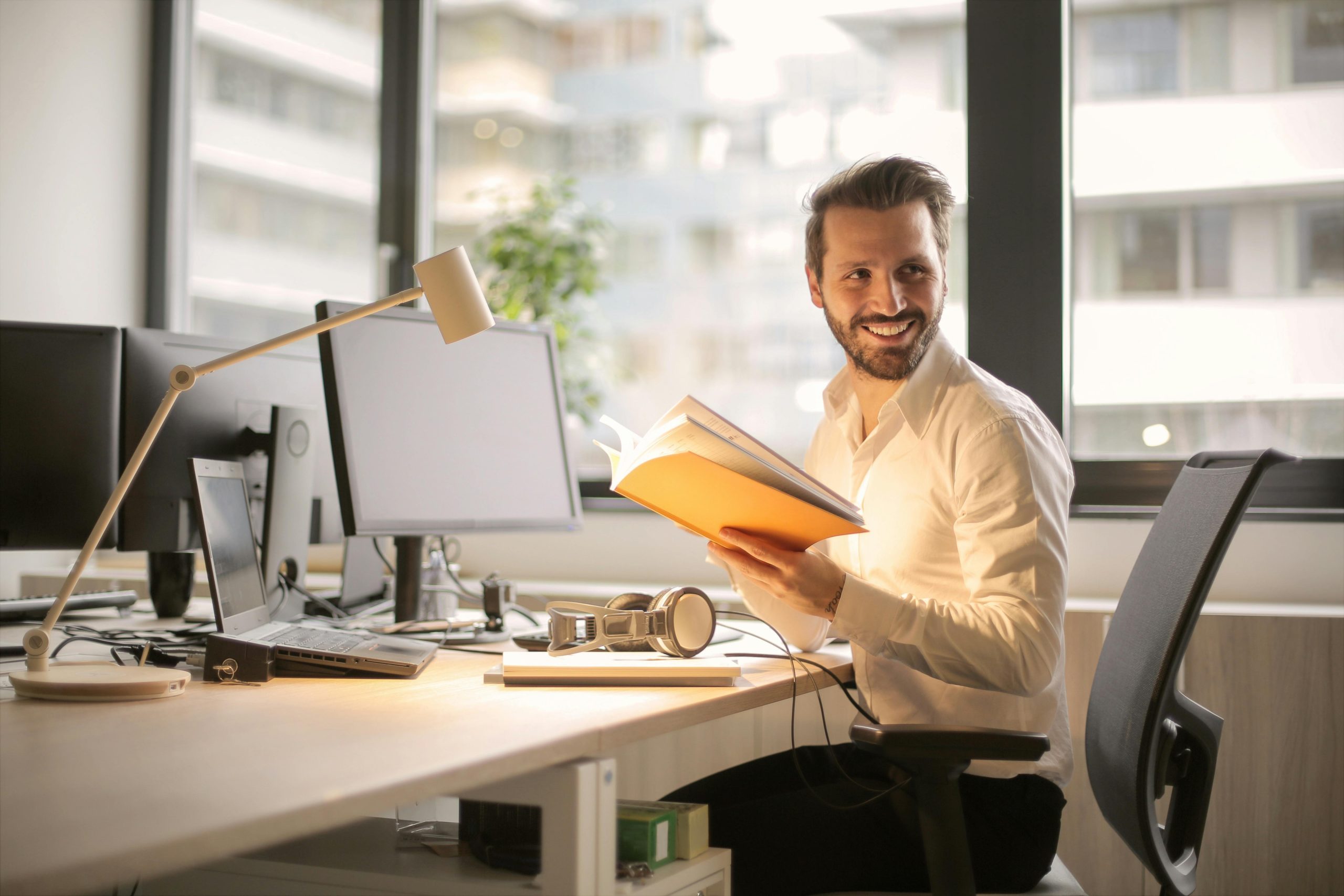 Man smiling while reading refund confirmation email