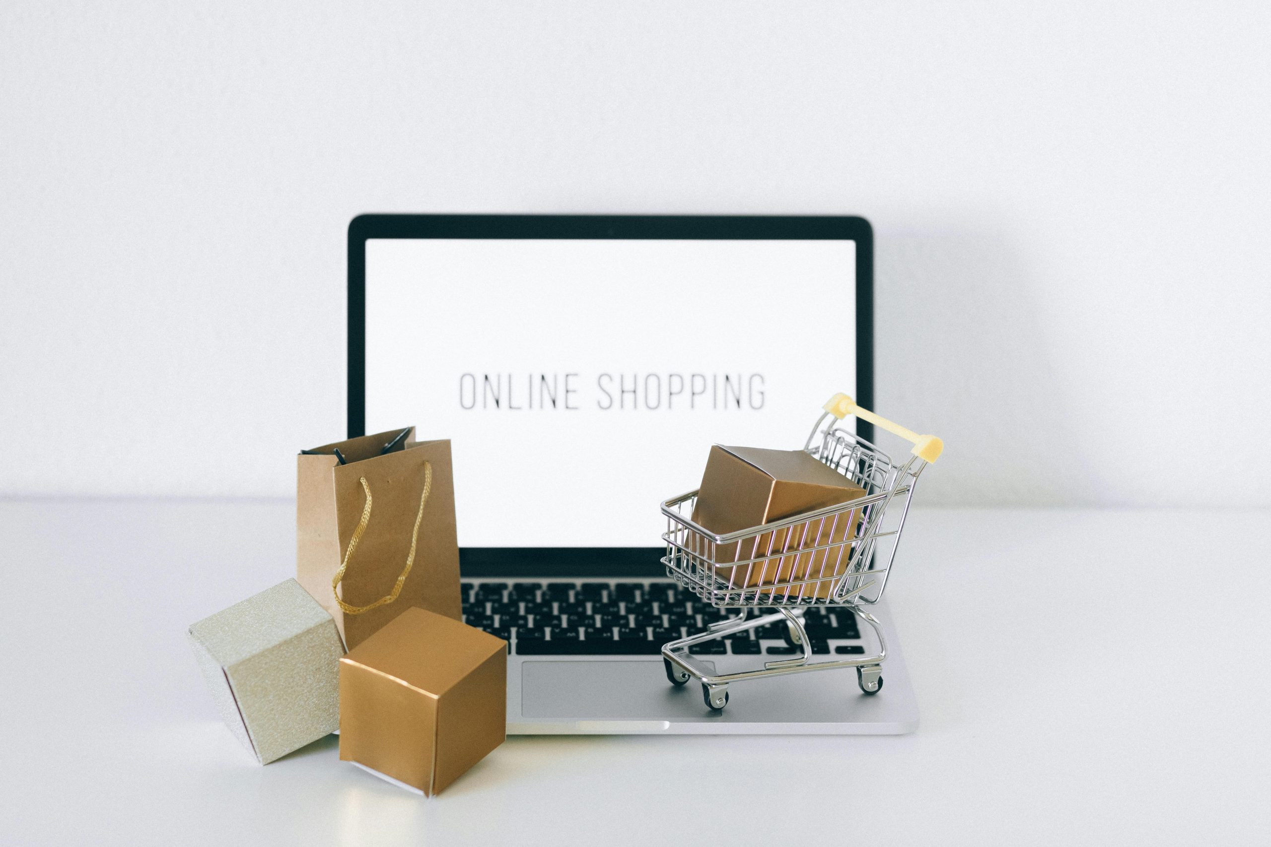 Woman holding a credit card while shopping online on her laptop
